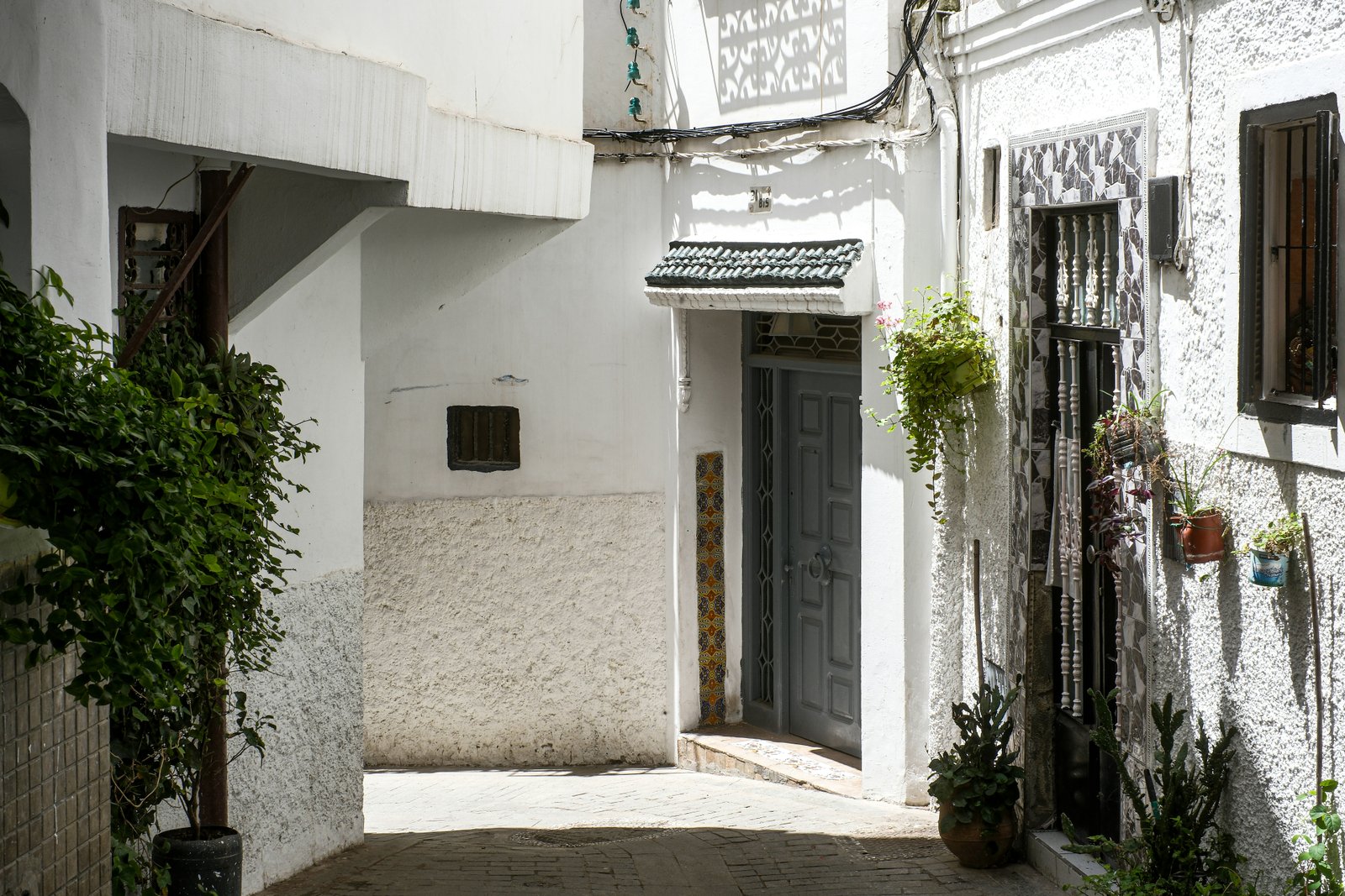 Narrow winding street in Tangier old town with traditional architecture and market stalls